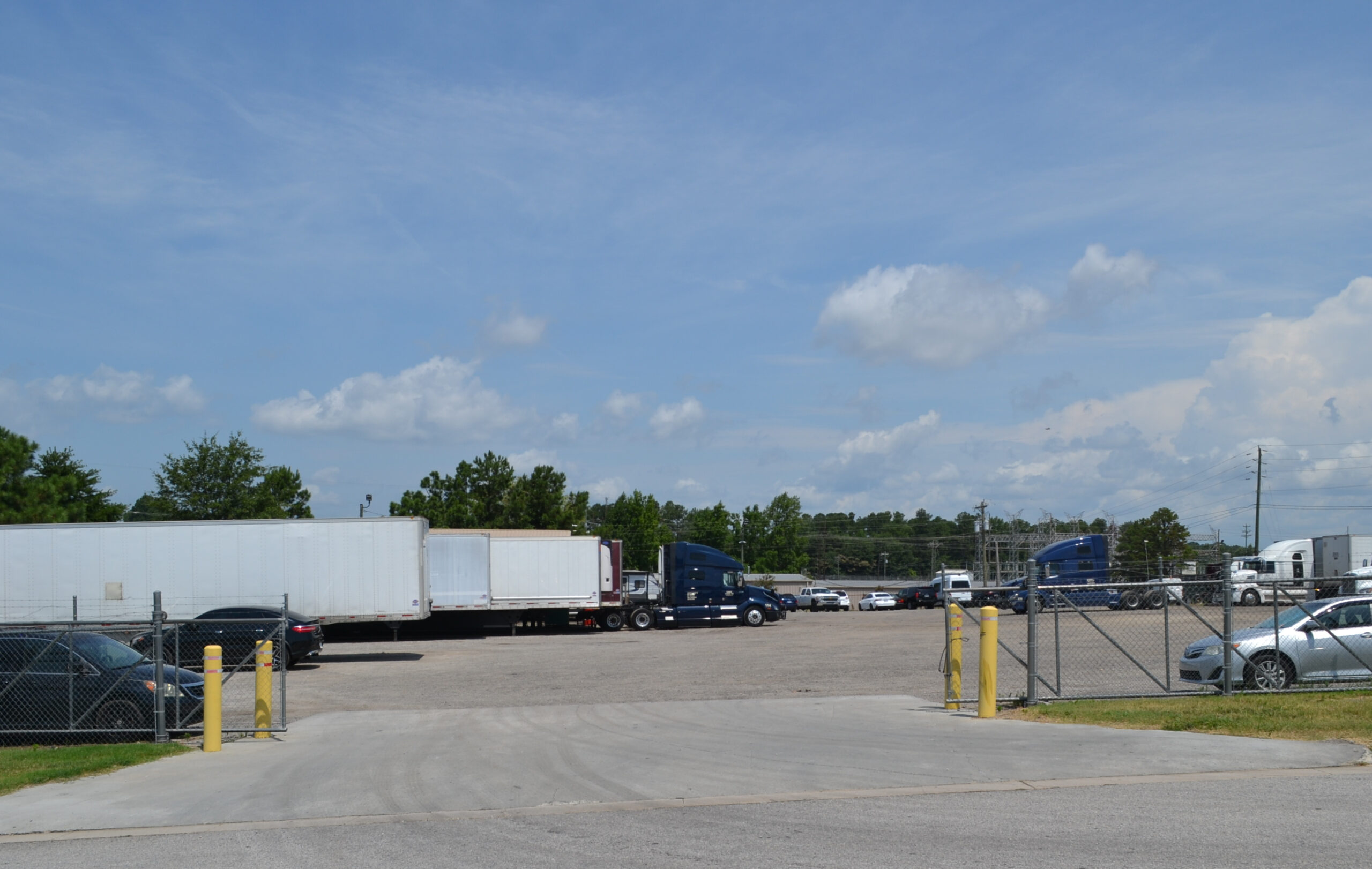 Entrance view of Big Wheels Repair in Gainesville, showing the heavy duty truck repair shop's parking area with several trucks and trailers.