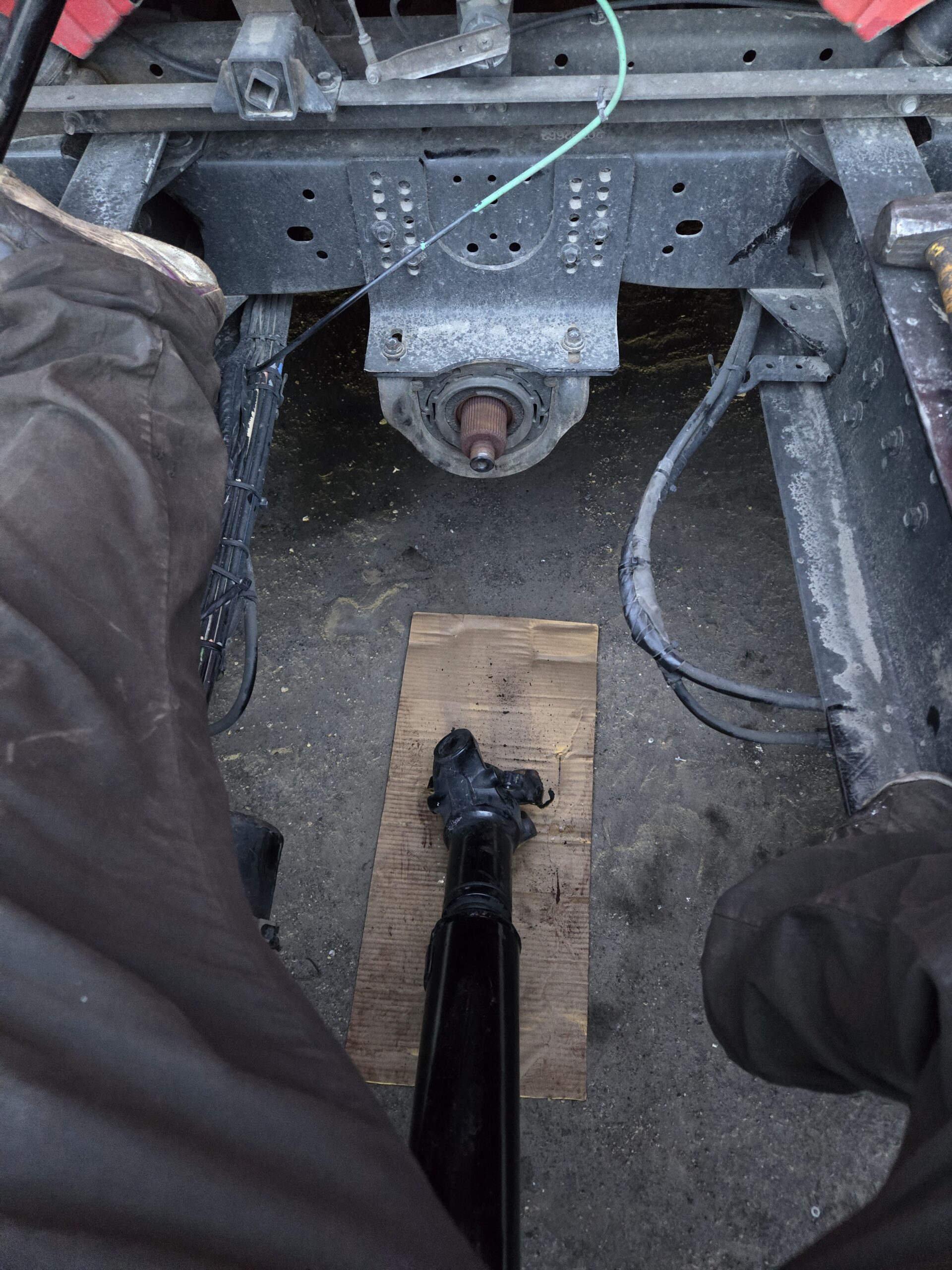 Mechanic working on a drive shaft at Big Wheels Repair in Gainesville, highlighting heavy duty truck repair and semi-truck maintenance services.