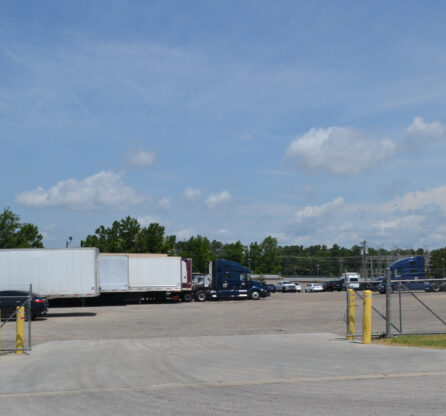 Entrance view of Big Wheels Repair in Gainesville, showing the heavy duty truck repair shop's parking area with several trucks and trailers.