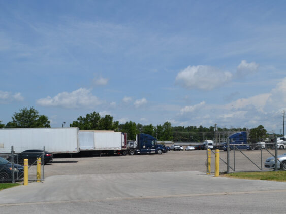 Entrance view of Big Wheels Repair in Gainesville, showing the heavy duty truck repair shop's parking area with several trucks and trailers.