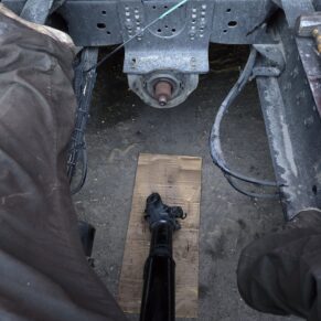 Mechanic working on a drive shaft at Big Wheels Repair in Gainesville, highlighting heavy duty truck repair and semi-truck maintenance services.