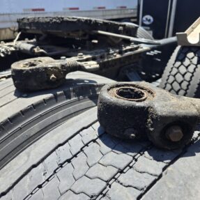 Close-up of damaged suspension components on a heavy duty truck at Big Wheels Repair in Gainesville, highlighting our repair services.