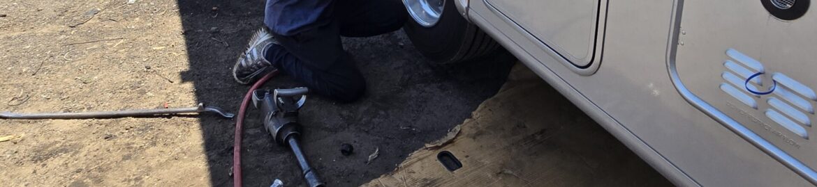 A mechanic performing tire services on a large vehicle at Big Wheels Repair in Gainesville, specializing in heavy duty truck repair and semi-truck maintenance.