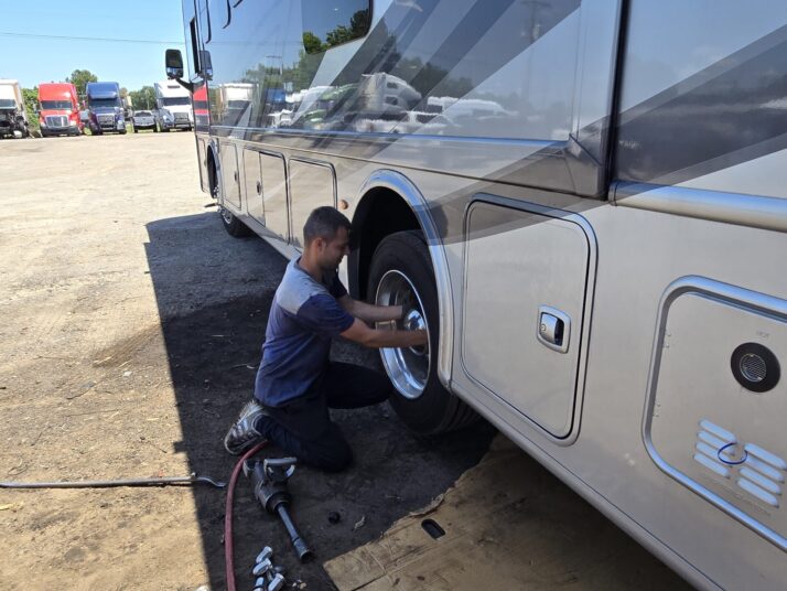 A mechanic performing tire services on a large vehicle at Big Wheels Repair in Gainesville, specializing in heavy duty truck repair and semi-truck maintenance.