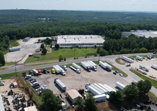 Aerial view of Big Wheels Repair in Gainesville, showing the heavy duty truck repair shop's facility and parking area with multiple trucks and trailers.