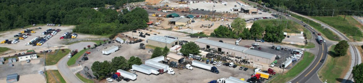 Aerial view of Big Wheels Repair in Gainesville, showcasing the heavy duty truck repair shop and commercial trailer repair services with several trucks and trailers on the premises.