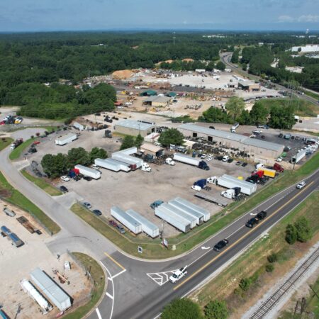 Aerial view of Big Wheels Repair in Gainesville, showcasing the heavy duty truck repair shop and commercial trailer repair services with several trucks and trailers on the premises.