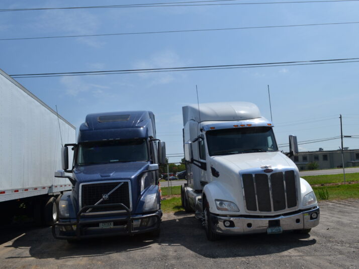 Two heavy duty trucks parked at Big Wheels Repair in Gainesville, showcasing our repair and maintenance services.