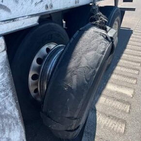 Damaged tire on a commercial trailer, highlighting the need for big truck tire services at Big Wheels Repair in Gainesville.