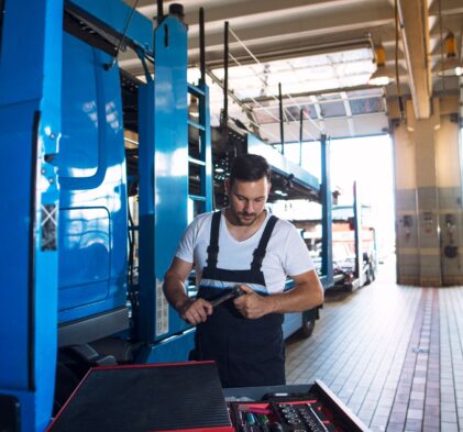 A technician working on a tool in a truck repair shop at Big Wheels Repair in Gainesville, showcasing heavy duty truck repair services