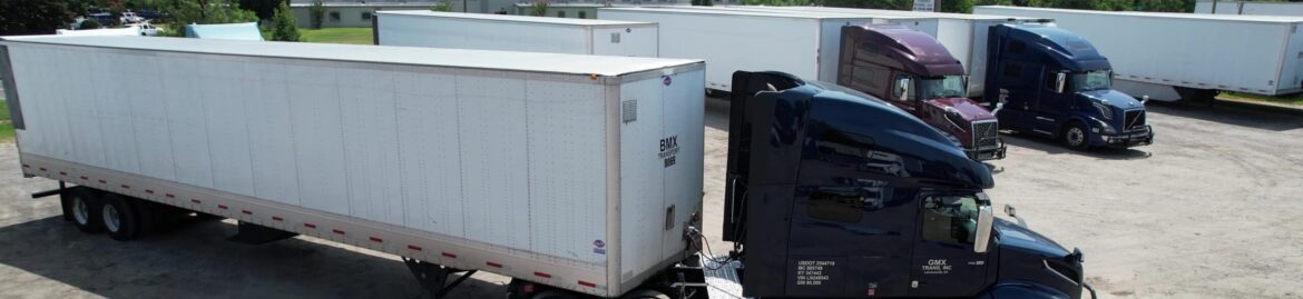 A heavy duty truck parked at Big Wheels Repair in Gainesville, ready for semi-truck maintenance and commercial trailer repair, with other big trucks visible in the background.