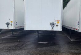 Front view of a white trailer standing in the parking lot of Big Wheels Repair Gainesville, GA